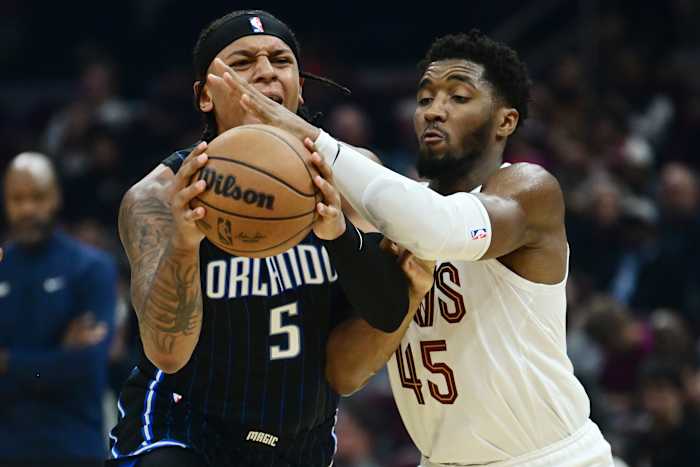 Cleveland Cavaliers guard Donovan Mitchell (45) defends Orlando Magic forward Paolo Banchero (5)